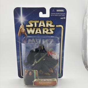 May include: A Star Wars Attack of the Clones Barriss Offee action figure in original packaging. The figure wears a black hooded robe and holds a green lightsaber. The card features the Star Wars logo, a warning label, and character artwork.