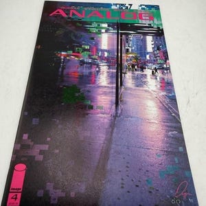 May include: Comic book cover for "Analog #4" with a cityscape scene in purple and pink hues. The title is in green and pink. The Image Comics logo and issue number are visible.