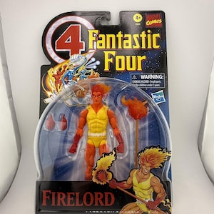 May include: A Firelord action figure from the Marvel Comics Fantastic Four series. The figure is in a clear plastic package. The figure is orange and yellow, with a flame-like head and a staff with a flame on top. The packaging has the Marvel Comics logo.