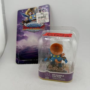 May include: A Skylanders SuperChargers Big Bubble Pop Fizz character figure in a clear plastic blister pack. The blue creature has a large orange horn-like accessory and stands on a brown base. The packaging includes the text Big Bubble Pop Fizz.