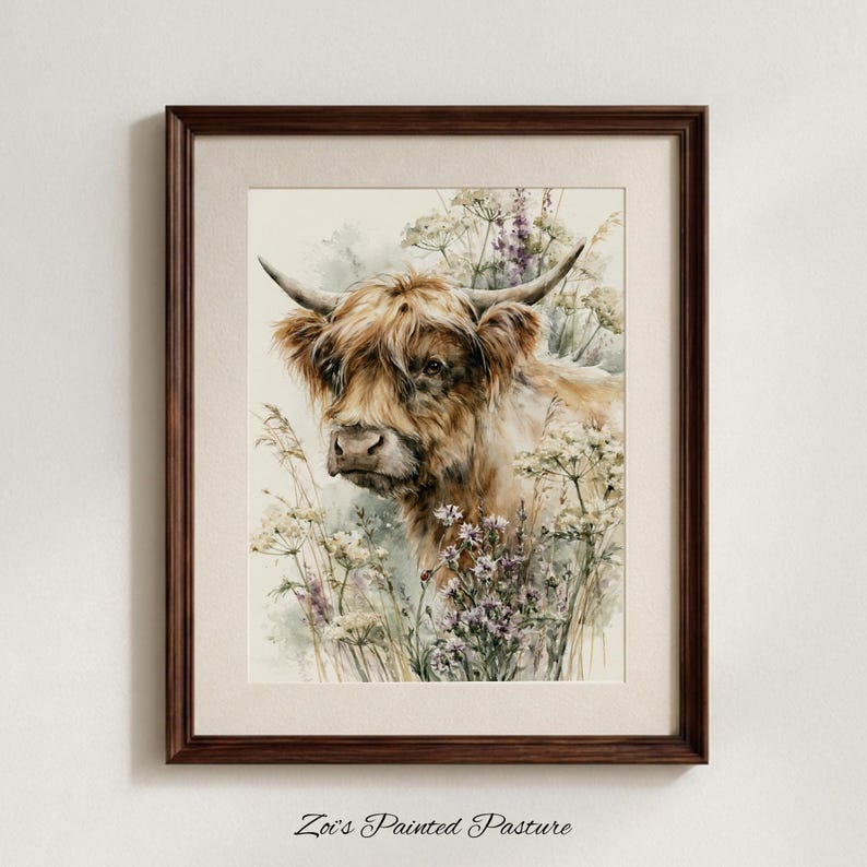 Framed watercolor highland cow print surrounded by wildflowers and lavender, displayed in dark walnut frame with cream mat on neutral gray wall, digital printable farmhouse wall art by Zoi's Painted Pasture