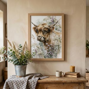 Watercolor highland cow wildflower printable wall art in natural wood frame above rustic farmhouse console table with galvanized bucket eucalyptus greenery gingham cloth and stoneware mug, cottagecore farmhouse home decor digital download