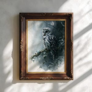 Barred owl watercolor printable wall art displayed in an ornate dark walnut and gold decorative frame on a neutral textured wall with soft natural window light shadows, moody cottagecore woodland aesthetic