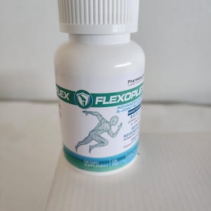 May include: A white plastic bottle of Flexoplex dietary supplement tablets with a white screw-top lid. The label features green and blue accents, a graphic of a human figure in motion, and text including Advanced Bone & Joint Support.