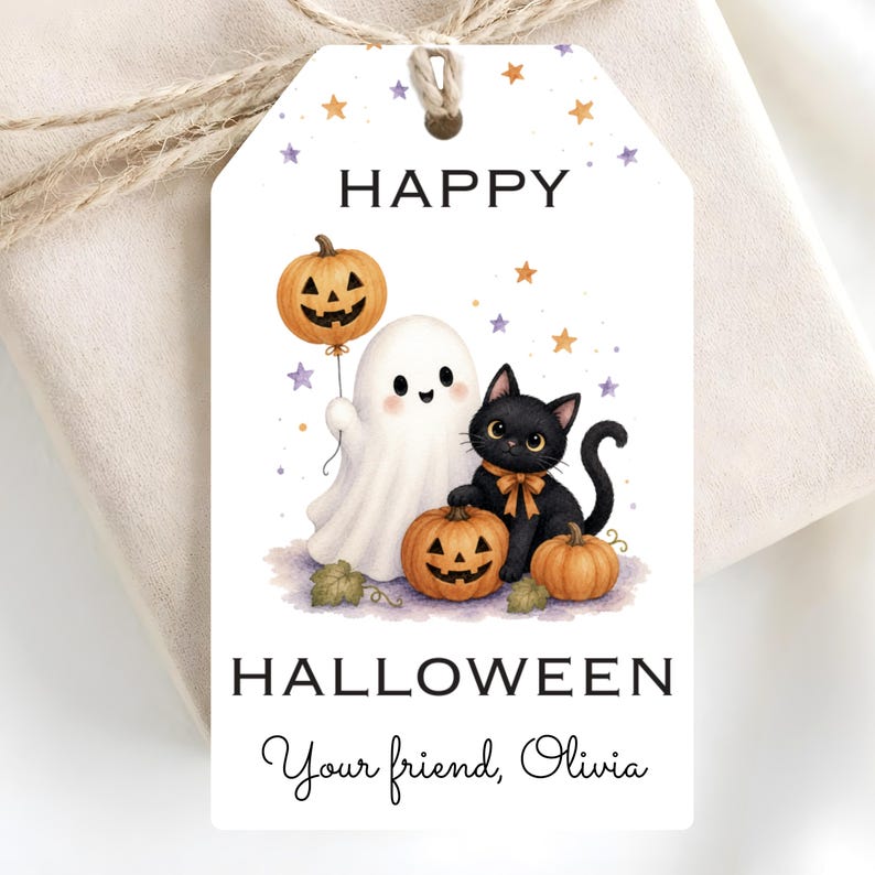 May include: A white rectangular gift tag with a hole at the top and twine string. The design features a ghost holding a jack-o'-lantern balloon, a black cat with an orange bow, and two pumpkins. Text reads HAPPY HALLOWEEN and Your friend, Olivia.