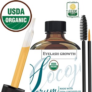 May include: A brown glass bottle with a black cap and a dropper. The bottle is labeled "EYELASH GROWTH Cocojo Serum" and "MADE WITH USDA CERTIFIED OF UNREFINED COLD PRESSED CASTOR OIL COCOJOJO.COM". The bottle has a USDA Organic seal and a CCOF Organic seal. There are two black mascara wands next to the bottle.