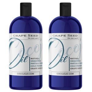 May include: Two dark blue bottles of CocoJojo Grape Seed Oil. Each bottle has a black cap and a white label with the text "Grape Seed" and "Coco Oil". The label also includes the text "Natural Unrefined Partially Filtered Cold Pressed Grape Seed Oil" and "COCOJOJO.COM".