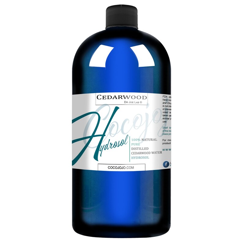 May include: A blue glass bottle with a white label that reads "Cedarwood Hydrosol" and "100% Natural Pure Distilled Cedarwood Water Hydrosol". The label also includes the website cocojojo.com and a Facebook logo.