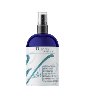 May include: A blue bottle of RICE fermented rice water with a white label. The label says "100% NATURAL FERMENTED RICE WATER ROSE HYDROSOL VITAMIN C & B5 D-PANTHENOL, ALOE GLYCERIN & SORBAT COCOJOJO.COM" and "RICE DR JOE LAB®".
