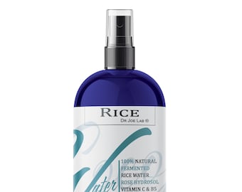 May include: A blue bottle of RICE fermented rice water with a white label. The label says "100% NATURAL FERMENTED RICE WATER ROSE HYDROSOL VITAMIN C & B5 D-PANTHENOL, ALOE GLYCERIN & SORBAT COCOJOJO.COM" and "RICE DR JOE LAB®".