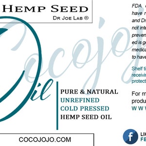 May include: A teal blue label with the text "Cocojojo" in a stylized font. The label also includes the text "Hemp Seed Oil", "Pure & Natural", "Unrefined", "Cold Pressed", and "Dr. Joe Lab". The label is for a 32 ounce bottle of hemp seed oil.