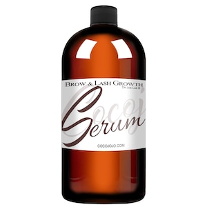 May include: A brown glass bottle with a black cap and a white label that reads "Brow & Lash Growth Dr Joe Lab&reg; Coco Serum COCOJOJO.COM".