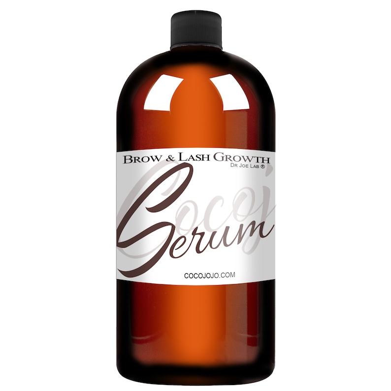 May include: A brown glass bottle with a black cap and a white label that reads "Brow & Lash Growth Dr Joe Lab&reg; Coco Serum COCOJOJO.COM".