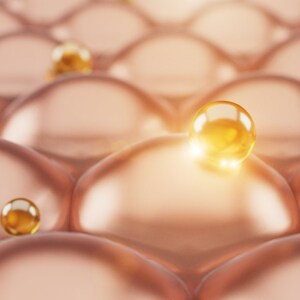 May include: Close-up of a textured, peach-colored surface with small, golden spheres scattered across it. The spheres are shiny and reflect light.