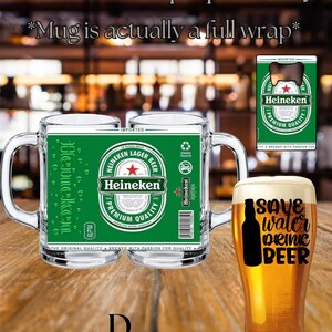 May include: A clear glass beer mug featuring a full-wrap green Heineken label with the text Heineken Lager Beer Premium Quality, a recycling symbol, and a barcode. Next to it is a tall beer glass with the black text Save water drink beer.