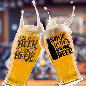 May include: Two clear glass beer glasses filled with golden lager, each featuring black text and graphics. The left glass displays 'The Best BEER is an OPEN BEER' with a small beer mug icon. The right glass shows 'SAVE water DRINK BEER' with a bottle silhouette.