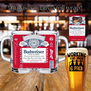 May include: A clear glass beer mug featuring a full-wrap Budweiser label with red, white, and blue branding, text, and a barcode. Beside it, a tall pilsner glass filled with beer displays the black text Working on my 6 PACK with bottle icons.
