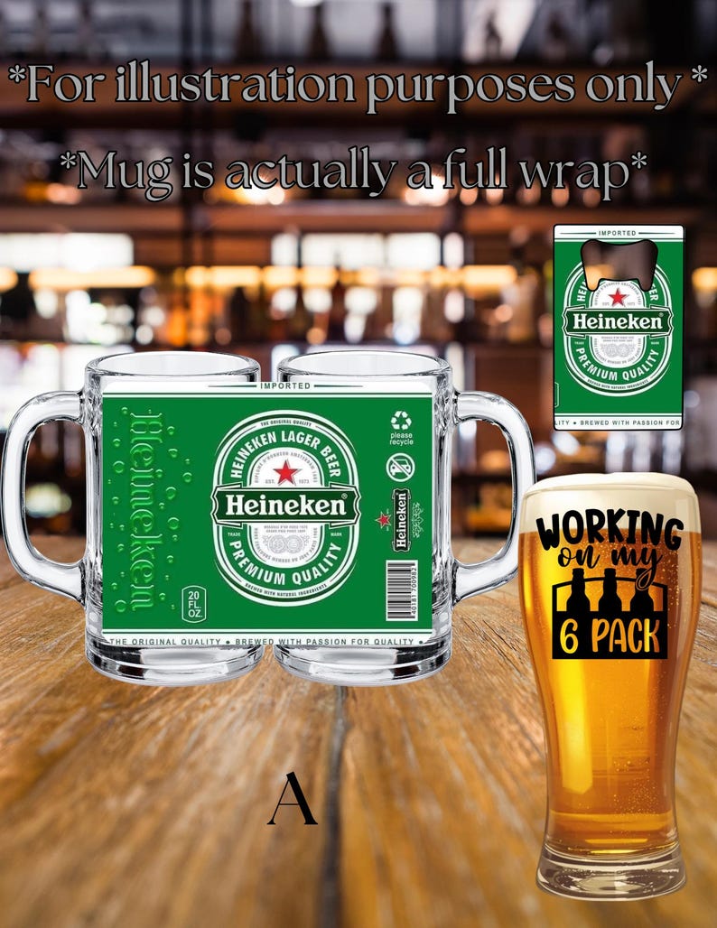 May include: A clear glass beer mug featuring a full-wrap green Heineken label with a red star, white text, and a barcode. Beside it, a tall glass filled with golden beer displays the black text 'WORKING on my 6 PACK' above a bottle icon.