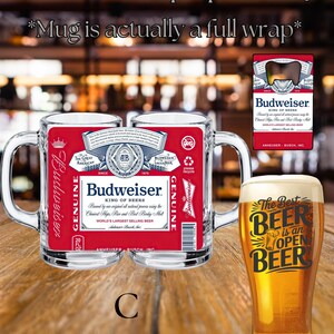 May include: A clear glass beer mug featuring a full-wrap Budweiser label with red, white, and blue branding, text, and a barcode. Beside it, a tall glass filled with golden beer displays the black text, The Best BEER is an OPEN BEER.