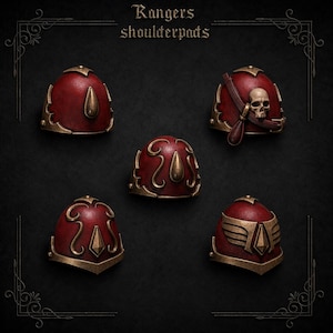 May include: Five miniature shoulder pads labeled Rangers shoulderpads. Each piece is painted deep red with metallic bronze trim and decorative accents, including a skull, wings, and teardrop shapes, arranged on a dark background.