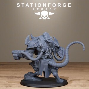 May include: A grey resin miniature figure of a creature with a long segmented tail, wearing armoured plating with circular details, connected by tubes to a weapon on its arm, standing on a circular base with the text STATIONFORGE LEGACY above.