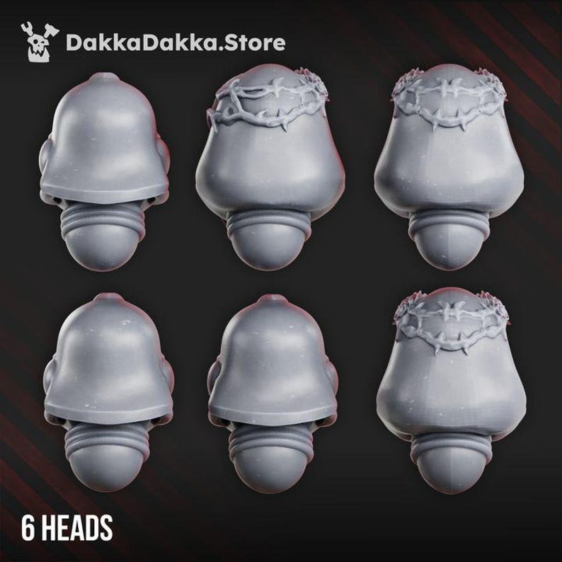 May include: Six grey miniature helmet heads arranged in two rows. The top row features a plain helmet, a helmet with a crown of thorns, and another with a crown of thorns. The bottom row shows two plain helmets and one with a crown of thorns.
