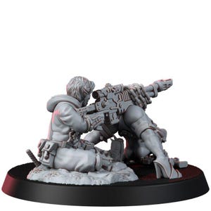 May include: A gray unpainted miniature figure of a person in a hooded jacket kneeling while aiming a long rifle with a scope. The figure wears tactical gear with pouches and is positioned on a circular base with a textured rocky ground surface.