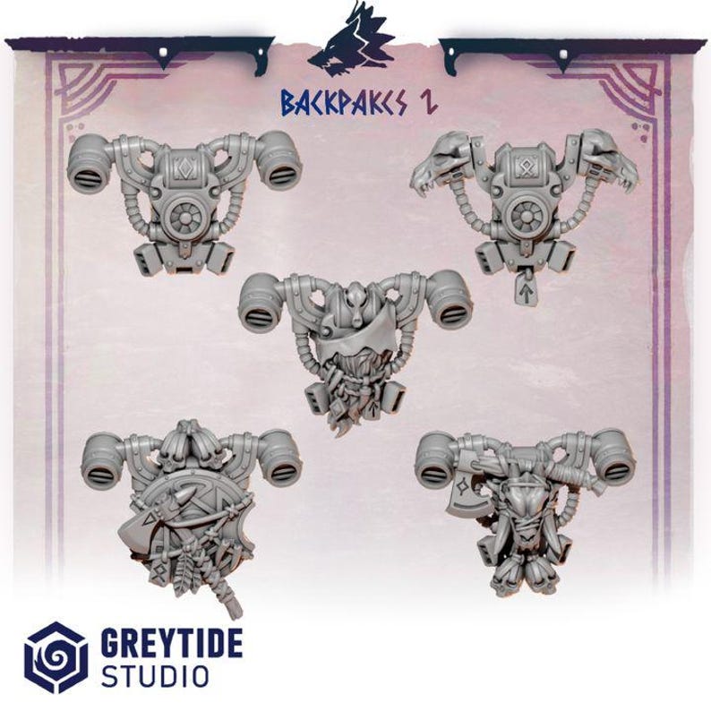 May include: A set of five grey resin miniature backpacks featuring mechanical designs, exhaust vents, and various adornments including skulls, axes, and runic symbols. The text "BACKPAKS 2" and "GREYTIDE STUDIO" is visible at the top and bottom.