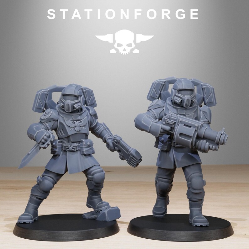 May include: Two grey unpainted miniature soldier figurines from StationForge. Each figure wears tactical armour, a helmet with a respirator, and a backpack. One figure holds a knife and a pistol, while the other carries a large heavy weapon.