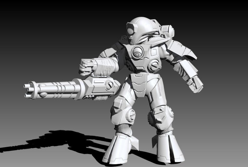 May include: A white, unpainted miniature figurine of a futuristic armored soldier in a standing pose. The figure wears a rounded helmet, chest plating, and heavy boots, and holds a large, multi-barreled rotary cannon in its right hand.