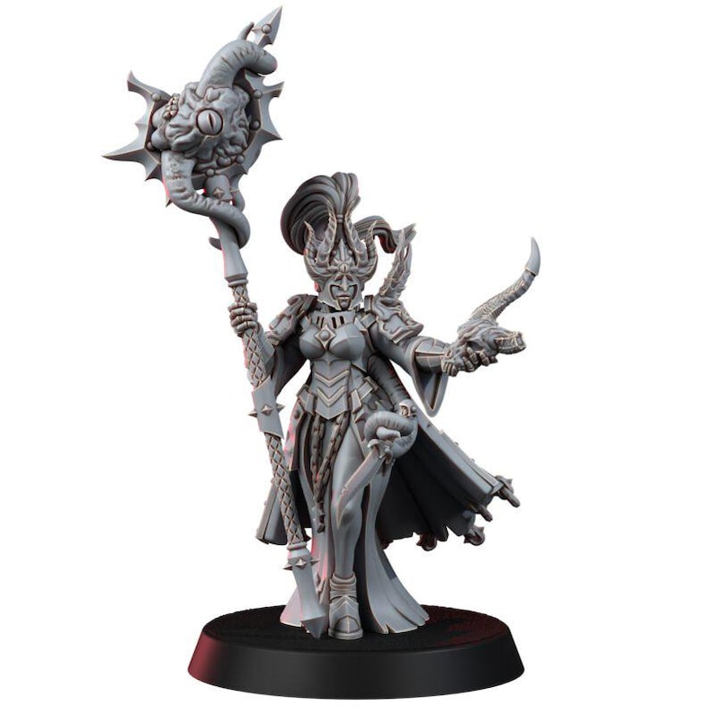 May include: A gray unpainted miniature figure wearing ornate armor and a tall helmet, holding a staff topped with a large eye-like orb in one hand and a small horned creature in the other, standing on a circular black base.