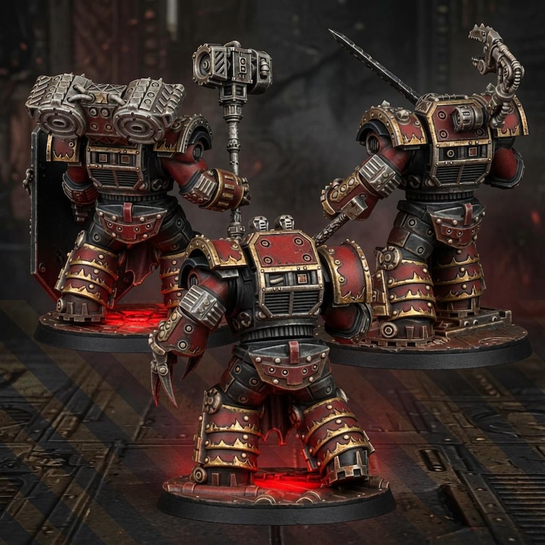 May include: Three miniature sci-fi warrior figures in heavy red and black armor with metallic silver trim. The figures are equipped with mechanical weapons, including a large hammer, a claw, and a sword, standing on circular bases.