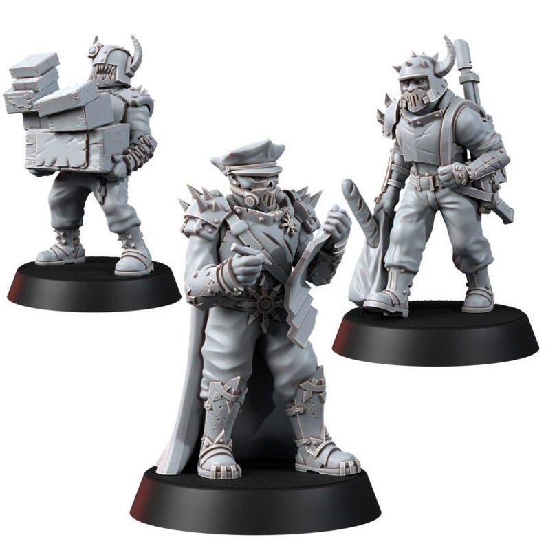 May include: Three unpainted gray miniature figures standing on black circular bases. One figure carries a stack of boxes, another wears a peaked cap and cape while holding a document, and the third wears a horned helmet and carries a baguette.