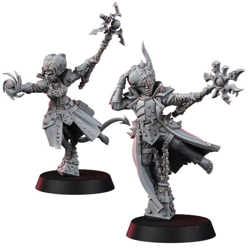 May include: Two unpainted grey plastic miniature figures standing on black circular bases. The left figure holds a staff and has a tail. The right figure wears a mechanical eye piece and holds a star-shaped weapon. Both wear long coats and armor.