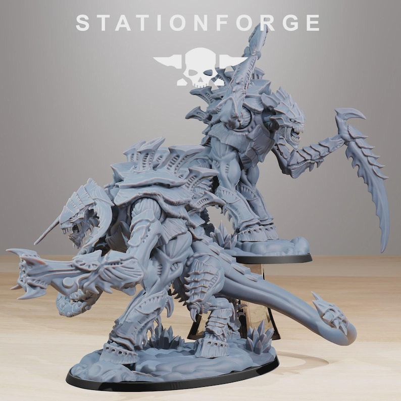 May include: Two grey, unpainted resin miniature figures featuring alien, insectoid creatures with segmented armor, sharp claws, and elongated tails. The text STATIONFORGE is visible at the top, along with a skull logo centered above the figures.