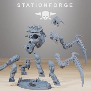 May include: A gray resin model kit featuring the text STATIONFORGE and a skull logo. The kit includes a torso, two serrated scythe-like arms, two legs, a head, and a textured oval base. These unpainted components are designed for assembly.