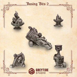 May include: A set of five grey miniature resin basing bits labeled Basing Bits 2 and Greytide Studio. The collection includes a flaming brazier, a candle holder, a broken fluted column with roses, a skull in a stone arch, and a skull-topped pedestal.