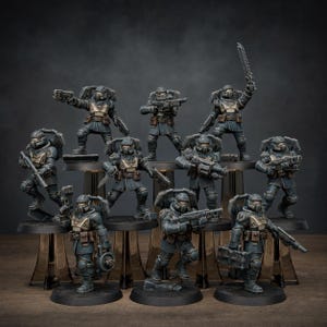 May include: A collection of ten miniature soldier figurines in dark blue and tan uniforms, each equipped with various futuristic weapons, helmets, and backpacks, standing on individual black circular bases arranged in a tiered display formation.