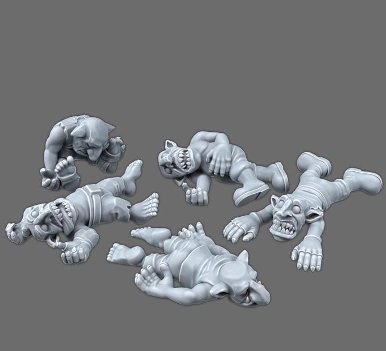 May include: A set of four unpainted gray resin miniature figures depicting goblin-like creatures in various prone and fallen positions. Each figure features pointed ears, sharp teeth, and detailed facial expressions, rendered in a matte finish.
