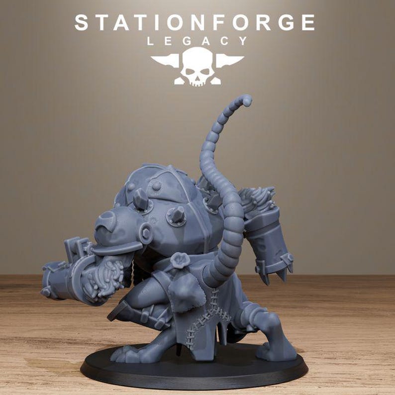 May include: A grey resin miniature figurine of a hunched, armoured creature with a long, segmented tail, bulky shoulder plates, and a mechanical-looking arm attachment. The figure stands on a circular black base, with the text STATIONFORGE LEGACY and a skull logo visible above it.