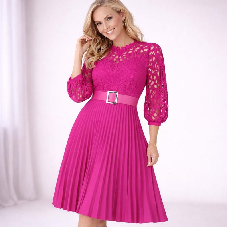 May include: A bright pink dress with a pleated skirt and a fitted bodice. The dress features a lace overlay on the sleeves and neckline, and a matching belt with a silver buckle. The dress is a vibrant color and has a classic, feminine silhouette.
