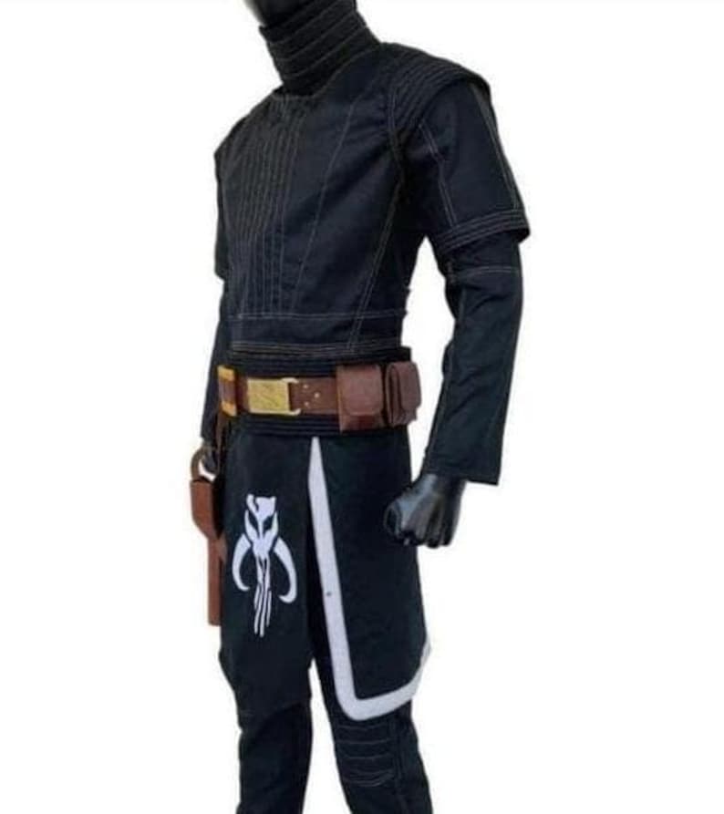 May include: Black costume with a high collar, featuring a brown belt with pouches and a holster. The pants have a white and black design with a skull emblem. The outfit is displayed on a mannequin.