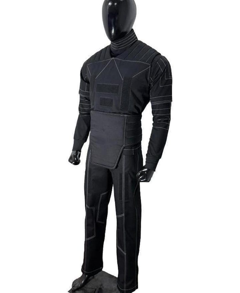 May include: A black long-sleeved shirt and matching trousers set featuring a high neck collar, structured chest panel, and reinforced waist section. The garment is detailed with white contrast stitching forming geometric patterns across the fabric.