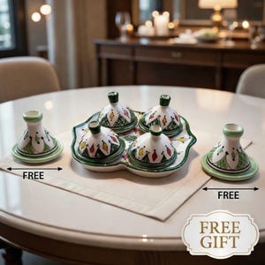 May include: A collection of small ceramic tagines with lids, decorated with colourful geometric patterns and green edging. The set includes a serving tray and two additional tagines. The word "FREE" is visible.