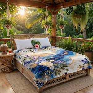 May include: A bed with a floral patterned blanket featuring blue, white, and gold accents. The bed is on a wooden frame, and the scene is set on a balcony with hanging plants and lush greenery. A tropical flower and leaf adorn the pillows.
