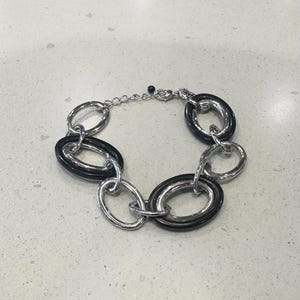 May include: A set of three ceramic mugs with a speckled, matte finish. The mugs are in shades of cream, light gray, and dark gray. Each mug has a simple, minimalist design, perfect for coffee or tea.