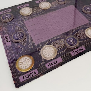 May include: A board game with a purple and gold design, featuring clock-themed tokens and player name labels. The board has a grid for tracking scores. Player names include Olivia, Mark, Jason, Matt, and others.