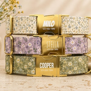May include: Three pet collars with floral patterns in cream, lavender, and sage green. Each collar features a gold-tone metal buckle engraved with a name and phone number: Milo 123-456-7890, Stella 123-456-7890, and Cooper 123-456-7890, with gold hardware.