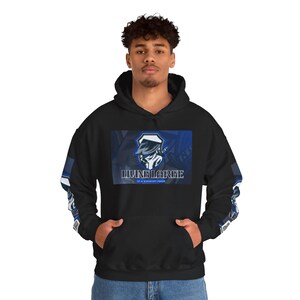May include: Black hooded sweatshirt with a front pocket and blue and white accents on the sleeves. The front features a rectangular graphic with a blue and white design and the words "LIVING LARGE" and "AT A REASONABLE PRICE".
