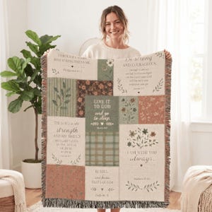 May include: A woven throw blanket featuring a patchwork design with muted green, brown, and cream tones. The blanket displays various floral patterns, plaid sections, and printed religious scripture verses including Philippians 4:12 and Joshua 1:9.